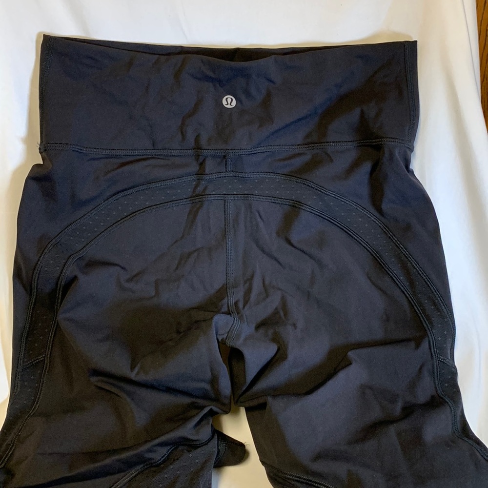 Lululemon 3/4 legging with polka dot mesh pattern fabric on the back of the leg.